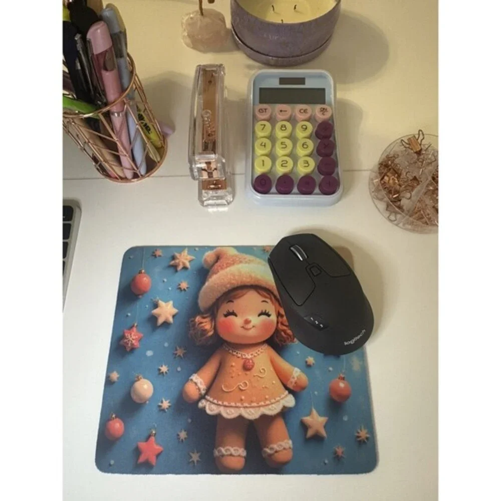 Adorable mouse pad featuring a cute Christmas gingerbread doll design with stars